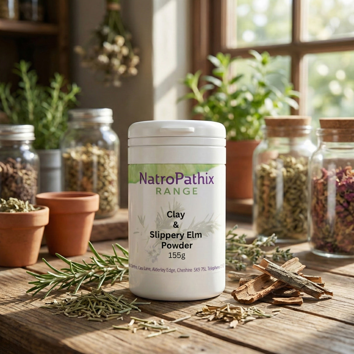 A jar of Clay & Slippery Elm Powder sits on a wooden table among herbs and glass jars—a natural intestinal purifier designed to support your gastro-intestinal tract.