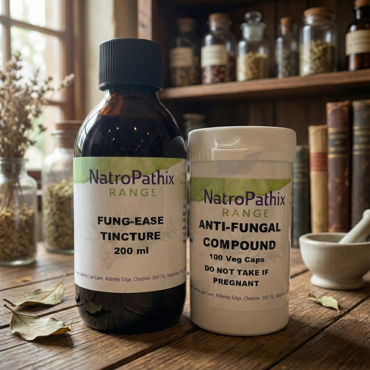 Two NatroPathix bottles—"Fung-Ease Tincture" and "Anti-Fungal Combination"—rest on a wooden table, offering natural support for those concerned about fungal overgrowth.