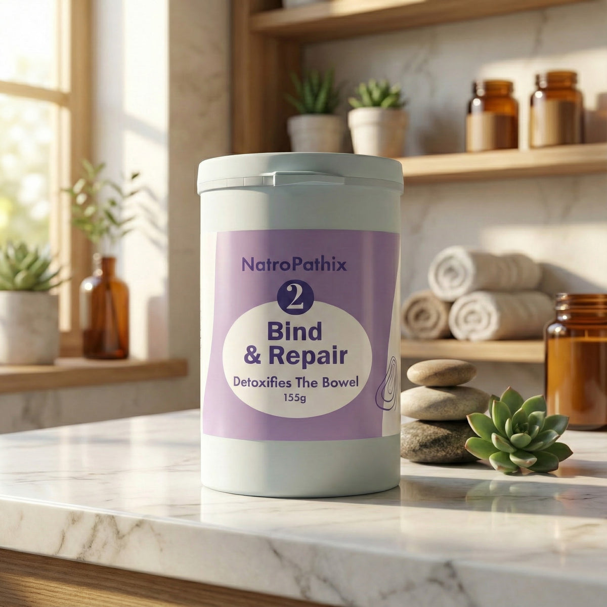 A 150gm container of Bind & Repair Powder, formulated for colon detox and heavy metal removal, sits on a marble counter surrounded by plants and towels.