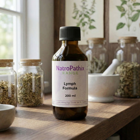 A bottle labeled "Lymph Formula - 200/300ml" rests on a wooden counter with herbs and a mortar, perfect support for lymphatic system detox or soothing swollen lymph nodes.