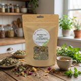 A bag of Allergi-Ease Tea - 100gms rests on the kitchen counter, surrounded by loose anti-histamine herbs and a steaming cup, ready to provide soothing hayfever relief.