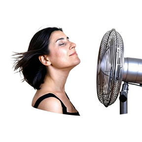 A woman with closed eyes enjoys the soothing breeze of a fan, capturing calmness—highlighting the comfort and relief that Hot Flushes and Anxiety Combination brings for hormonal balance in daily life.
