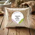 A clear packet labeled "Liquorice Root - Tincture, Herbal Tea or Powder" sits on a wooden surface with herbs in the background—traditionally used to help soothe heartburn and acid reflux.