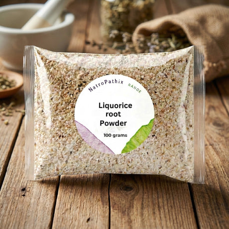 A clear packet labeled "Liquorice Root - Tincture, Herbal Tea or Powder" sits on a wooden surface with herbs in the background—traditionally used to help soothe heartburn and acid reflux.