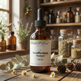 A 50ml brown dropper bottle labeled "Snuffle-Ease Tincture - 50ml" sits on a wooden table amid herbs and apothecary jars—formulated to support your immune system naturally.