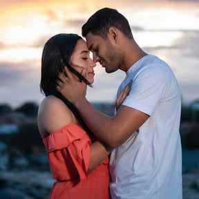 A couple embraces at sunset, foreheads touching and smiling with eyes closed, their bond deepened by Libido Enhancing Combination – Men.