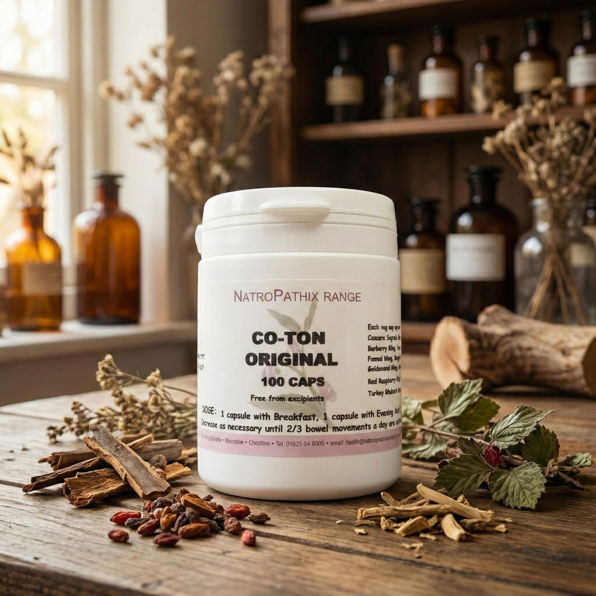 A bottle of Co-Ton Original - 100 Caps rests on a rustic table with dried herbs and glass bottles, emphasizing its herbal formula crafted to help reduce bloating.