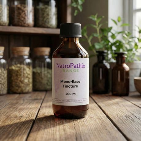 A bottle of "Meno-Ease Tincture - 200/300ml" sits on a wooden table with jars of herbs behind it, promoting menopause relief with phyto-oestrogenic herbs.