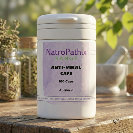 A white container labeled "Anti-Viral Herbs - 150 Capsules" sits on a wooden surface with herbs in the background, naturally supporting your immune system.