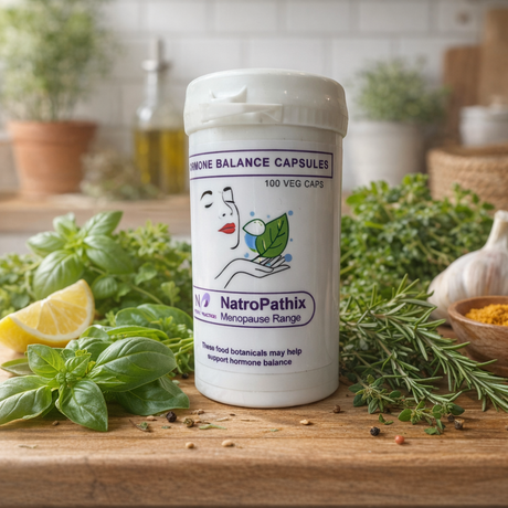 A bottle of Hormone Balance Capsules - 100 is displayed on a kitchen counter, surrounded by fresh herbs and a lemon.